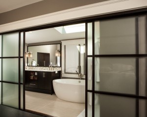 contemporary-bathroom-with-sliding-partition-doors-with-black-frame-color-also-beige-tile-flooring-and-white-modern-bathtub-and-modern-faucet-also-elegant-dark-brown-vanity-also-mosaic-tile-and-modern-mirror